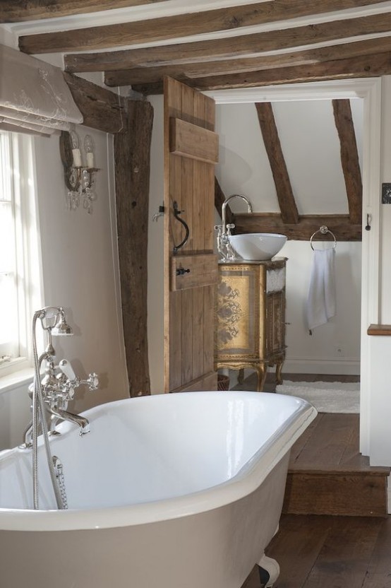 a rustic vintage bathroom with wooden beams on the walls and ceiling, a vintage tub and vintage furniture