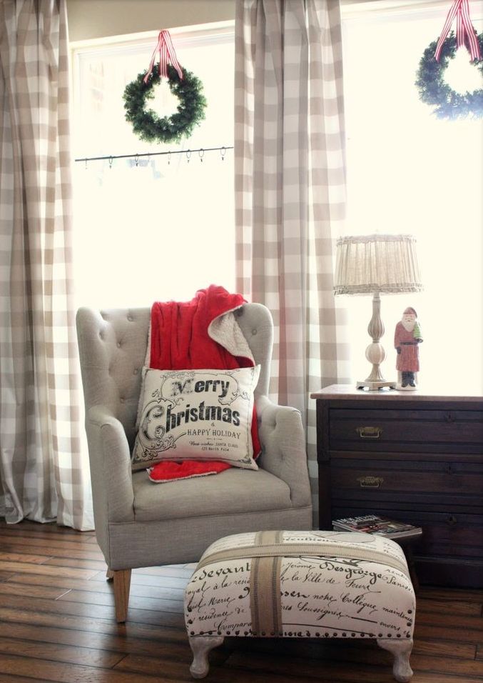 Cozy plaid curtains, a red blanket and some pillows make the living room holiday ready and very welcoming