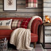 plaid pillows and a knit blanket make the living room cozy and cool, it feels holiday-like