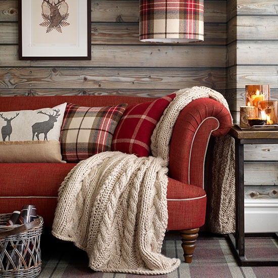 Plaid pillows and a knit blanket make the living room cozy and cool, it feels holiday like