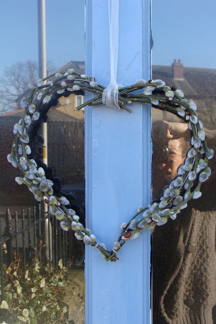 a willow heart-shaped wreath is a nice front door decoration for spring, Valentine's Day and Easter