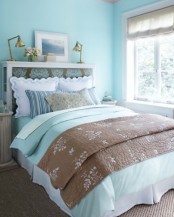 bright and fresh blues in the ddecor echo int he bedding, too, and make the bedroom look fresh