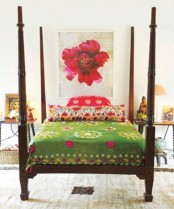 bright bedding and a colorful artwork make the bedroom feel fresh, bright and spring-like