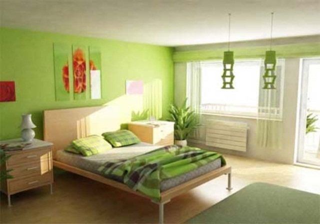 A bright bedroom in neon green, a floral three piece artwork looks bold and springy
