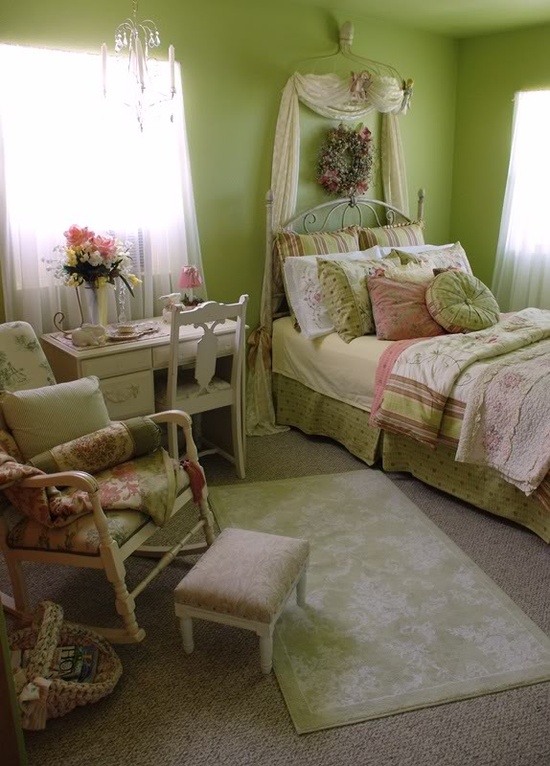 a spring bedroom with green walls, floral bedding and bright linens looks bold and bright