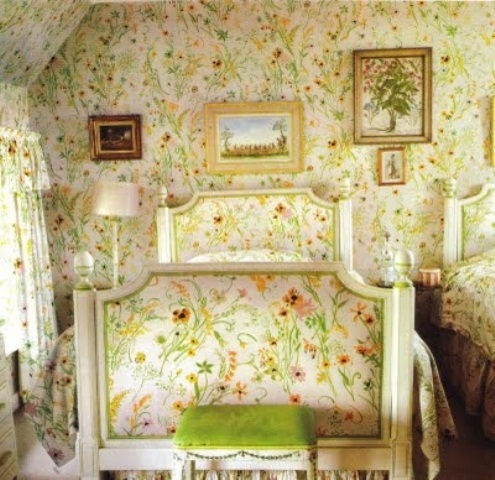 An all floral bedroom with bright wallpaper and a matching bed is a unique space that all feels like spring