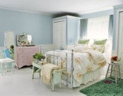 pastel walls and furniture, floral bedding make the bedroom feel like spring