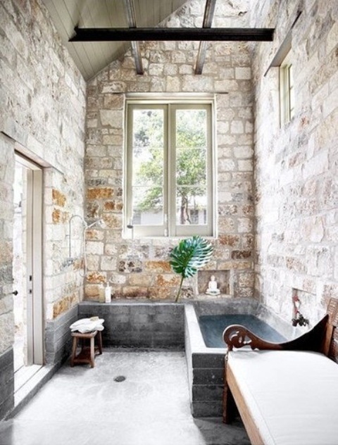 A gorgeous wabi sabi bathroom all clad with stone and with a brick clad bathtub is a cool idea for an indoor outdoor space