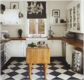 an elegant black and white kitchen with shaker style cabinets, butcherblock countertops, a checked floor, a stained folding table as a kitchen island