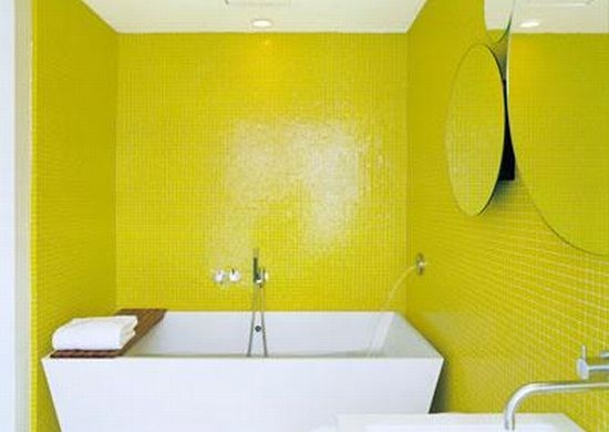 a modern neon yellow bathroom with modenr white appliances and round mirrors without any frames is a cool space to be in